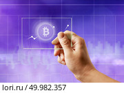 Icon bitcoin on a glass screen with a graph of crypto currency on an ultraviolet background. Finance and technology concept can be used for video or site cover. Icon bitcoin on a glass screen with a graph of crypto currency on an ultraviolet background. Стоковое фото, агентство Ingram Publishing / Фотобанк Лори