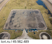 Kiev, Ukraine.- February 02,2018: Aerial view on a hippodrome with a horse, people and shadows. Photo taken with a drone. Kiev, Ukraine.- February 02,2018: Aerial view on a hippodrome with a horse, people and shadows. Редакционное фото, агентство Ingram Publishing / Фотобанк Лори