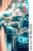 Sleek orange car's front fender and side mirror are prominently featured against blurred background of warm, shimmering bokeh lights. Perfect for automotive, luxury and technology themes. Стоковое AI-изображение, AI-художник Елена Никишина / Фотобанк Лори