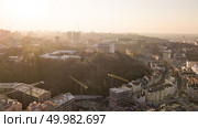 Aerial view of Artistic Kiev School and Construction workers at work are at the top of the building on Vozdvizhenka. Kiev is the capital and most populated city of Ukraine. Photo by drone. Artistic Kiev School and Construction workers at work are at the top of the building on Vozdvizhenka in Kiev. Стоковое фото, агентство Ingram Publishing / Фотобанк Лори