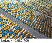 KIEV, UKRAINE - July 19, 2018. Panoramic view from drone on empty even rows tribunes of sports complex NSC Olimpiysky before soccer game in the summer time.. KYIV, UKRAINE - July 19, 2018. Aerial view empty tribunes of NSC Olimpiysky before the game in blue and yellow colors. Редакционное фото, агентство Ingram Publishing / Фотобанк Лори