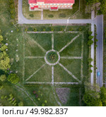 The panoramic bird’s eye view shooting from drone of central part of dendrological park with parterre flower beds in regular style in Sofiyivka Park and Uman, Ukraine. Aerial panoramic view from the drone to the national dendrological park Sofiyivka in city Uman, Ukraine in the summer at sunset. Стоковое фото, агентство Ingram Publishing / Фотобанк Лори