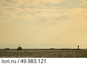 View of the cargo ships, tugboats in the port on the roadstead on the background of cloudy sky.. Landscape panoramic view from the sea to the historical part of Istanbul, Turkey. Стоковое фото, агентство Ingram Publishing / Фотобанк Лори