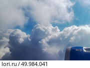side airplane engine captured while airplane flying over the sky. airplane’s wing over a blue and cloudy sky. Стоковое фото, агентство Ingram Publishing / Фотобанк Лори