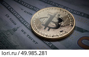 Golden bitcoin coins on a paper dollars money. Virtual Crypto currency. New virtual money Dollars money. Concept of shadow economy. Coin bitcoin on the background of a pile of dollar bills as underground economy. Стоковое фото, агентство Ingram Publishing / Фотобанк Лори