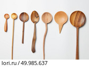 Assorted different kitchen wooden utensils cutlery on a white background. Assorted different kitchen wooden utensils cutlery. Стоковое фото, агентство Ingram Publishing / Фотобанк Лори