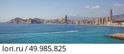 A small trawler sailing into Benidorm bay. City scape panorama. Стоковое фото, агентство Ingram Publishing / Фотобанк Лори