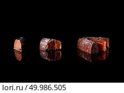 cut three chocolates candies isolated on a black background. section of delicious chocolates candies. Стоковое фото, агентство Ingram Publishing / Фотобанк Лори