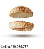 Roasted toasted burger top without fillings flying, levitating at white.. Burger bun empty isolated. Стоковое фото, агентство Ingram Publishing / Фотобанк Лори