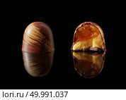tasty yellow chocolate candy on a black background. chocolate candy on black background. Стоковое фото, агентство Ingram Publishing / Фотобанк Лори