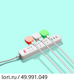 Three electrical plugs connected to a power strip or extension strip on a green background. Three electrical plugs connected to power strip. Стоковое фото, агентство Ingram Publishing / Фотобанк Лори