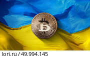 bitcoin Gold on a Ukrainian flag background. State regulation of the crypto currency market. Ukraine is one of the five fastest growing countries in the world in the crypto currency market. Cryptocurrency and blockchain trading concept. Can be used for video or site cove. bitcoin Gold on a Ukrainian flag background. Ukraine, successfully developing country in the crypto currency market. Стоковое фото, агентство Ingram Publishing / Фотобанк Лори