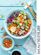 Bowl with grilled chicken meat, brown rice and fresh vegetable salad of avocado, radish, cabbage kale, carrot, and lettuce leaves. Healthy and delicious dietary lunch. Top view. Стоковое фото, агентство Ingram Publishing / Фотобанк Лори