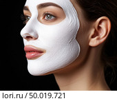 Cosmetic fabric mask on a woman's face. Стоковое AI-изображение, AI-художник Анна Никонорова / Фотобанк Лори