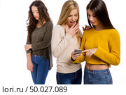 Teenagers making gossip from other girl. Стоковое фото, агентство Ingram Publishing / Фотобанк Лори