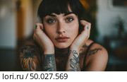 Charming woman showcasing intricate tattoos on her arms, displaying detailed designs and colorful artwork. Стоковое AI-изображение, AI-художник Данила Большаков / Фотобанк Лори