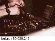 DJ mixes tracks at a party. DJ control panel. Стоковое фото, агентство Ingram Publishing / Фотобанк Лори