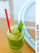 iced pandan and kale fruit juice smoothie cocktail and mocktail on glass table. Стоковое фото, агентство Ingram Publishing / Фотобанк Лори