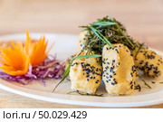 deep fried organic tofu topping with organic black sesame seaweed and leek. Thai Chinese organic street food and cuisine. Стоковое фото, агентство Ingram Publishing / Фотобанк Лори