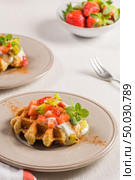 Fresh egg waffles dessert for breakfast with yogurt, strawberries and kiwi. Стоковое фото, агентство Ingram Publishing / Фотобанк Лори