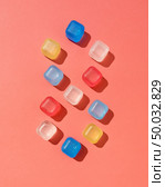 Pattern from colored ice cubes with shadows on a background in a color of the year 2019 Living Coral Pantone, copy space. Figure 8 eight. Top view.. Number eight from colorful plastic ice cubes on a background in a color of the year 2019 Living Coral Pantone, copy space. Flat lay. Стоковое фото, агентство Ingram Publishing / Фотобанк Лори