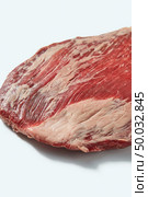 Fresh organic natural raw meat for grill, close up structure ob beef on a white background, copy space.. Fresh organic natural raw flank steak, close up structure ob beef on a white background, copy space. Стоковое фото, агентство Ingram Publishing / Фотобанк Лори