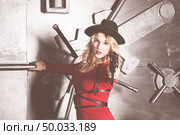 dangerous blonde in a red dress keep covered. Стоковое фото, агентство Ingram Publishing / Фотобанк Лори