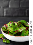 Fresh chard leaves on black background. Стоковое фото, агентство Ingram Publishing / Фотобанк Лори