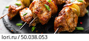 Grilled meat skewers, shish kebab on black background, banner. Стоковое фото, агентство Ingram Publishing / Фотобанк Лори