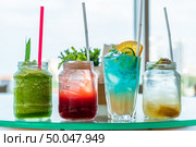 variety of iced fruit juice cocktail and mocktail on glass table. Стоковое фото, агентство Ingram Publishing / Фотобанк Лори