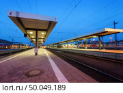 Beautiful night industrial landscape, modern railway station in Nuremberg, Germany. Railroad platform on the background of blue sky. Стоковое фото, агентство Ingram Publishing / Фотобанк Лори