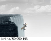 Against the flow business concept as a metaphor for swimming upstream against the current as a symbol for determination and courage to go opposite of the mainstream with 3D illustration elements. Стоковое фото, агентство Ingram Publishing / Фотобанк Лори