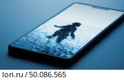 A phone with a blue background and a man in the water. Стоковое AI-изображение, AI-художник Ярославский Максим / Фотобанк Лори