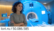 A woman stands in front of a medical imaging machine. Стоковое AI-изображение, AI-художник Ярославский Максим / Фотобанк Лори