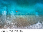 Aerial view of swimming woman in mediterranean sea in Oludeniz, Turkey. Beautiful summer seascape with girl, clear azure water, waves and sandy beach in sunny day. Top view from flying drone. Nature. Aerial view of swimming woman in mediterranean sea . Стоковое фото, агентство Ingram Publishing / Фотобанк Лори