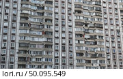 Facade of residential building with many balconies and air conditioners showing urban density. Стоковое видео, видеограф Mikhail Davidovich / Фотобанк Лори