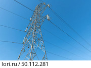 Electricity transmission pylon silhouetted against blue sky. Стоковое фото, агентство Ingram Publishing / Фотобанк Лори