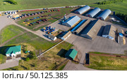 Russia, Tambov region, May 05 2025, farm with many tractors and buildings. Редакционное фото, фотограф Скрипачев Антон / Фотобанк Лори