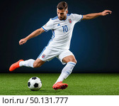 A soccer player in a white uniform kicks a soccer ball. Стоковое AI-изображение, AI-художник Ярославский Максим / Фотобанк Лори