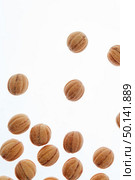 Feshly baked homemade cakes in a shape of walnuts filled milk cream on a white background with copy space.. Falling homemade cookies walnuts on a white background. Стоковое фото, агентство Ingram Publishing / Фотобанк Лори