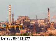 Steel factory with smokestacks at sunset. metallurgical plant. steelworks, iron works. Heavy industry in Europe. Air pollution from smokestacks, ecology problems. Industrial landscape. Стоковое фото, агентство Ingram Publishing / Фотобанк Лори