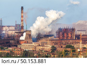 Steel factory with smokestacks at sunset. metallurgical plant. steelworks, iron works. Heavy industry in Europe. Air pollution from smokestacks, ecology problems. Industrial landscape. Стоковое фото, агентство Ingram Publishing / Фотобанк Лори