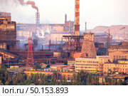 Industrial landscape in Ukraine. Steel factory with smog at sunset. Pipes with smoke. Metallurgical plant. steelworks, iron works. Heavy industry. Ecology problems, atmospheric pollutants. Стоковое фото, агентство Ingram Publishing / Фотобанк Лори