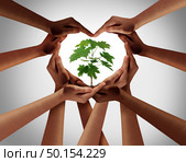 Charity concept or earth day global diversity support celebration as a community symbol for friendship and volunteer donation as a group of diverse people forming a heart shape as a composite image. Стоковое фото, агентство Ingram Publishing / Фотобанк Лори
