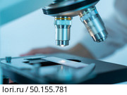 Close-up shot of microscope with metal lens at laboratory. Стоковое фото, агентство Ingram Publishing / Фотобанк Лори