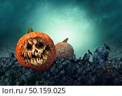 Halloween pumpkin grave and creepy zombie gourd in a haunted spooky graveyard as a grimace of horror on a scary jack o lantern with 3D illustration elements. Стоковое фото, агентство Ingram Publishing / Фотобанк Лори