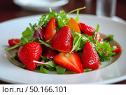 Fresh salad featuring vibrant strawberries, peaches, and mixed greens, elegantly presented in a white bowl, showcasing colorful ingredients and healthy eating lifestyle. Стоковое AI-изображение, AI-художник Ирина Ручушкина / Фотобанк Лори