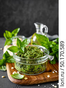 Traditional italian pesto alla genovese with fresh basil leaves, pine nuts, olive oil, garlic and parmesan cheese. Стоковое фото, агентство Ingram Publishing / Фотобанк Лори