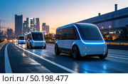 Autonomous electric shuttles travel through a futuristic cityscape at dusk, illustrating smart urban transport and sustainable mobility trends. Стоковое AI-изображение, AI-художник Ольга Сухарева / Фотобанк Лори