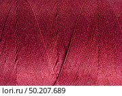 Macro close-up of fine dark pink cotton wound round spool. Стоковое фото, фотограф Camptoloma / Фотобанк Лори